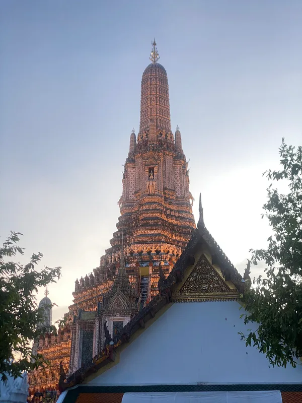 Wat Arun in Bangkok lit up at sunset